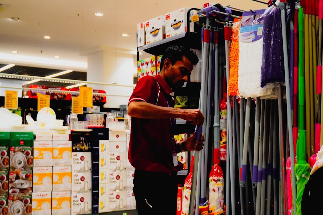 services-02 man-arranging-cleaning-supplies-in-a-store-v-isgw3g-de
